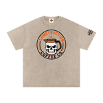 Beige t-shirt with skull and coffee mug graphic on a white background