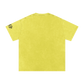 Yellow t-shirt with text on sleeve against a white background