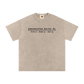 Beige t-shirt with black text on a white background