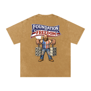 Beige t-shirt with a graphic of a man in chains wearing an American flag shirt and 'Foundation of Freedom' text on a white background.