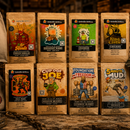 Collection of branded products including t-shirts, boxes, and a helmet on a wooden surface.