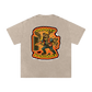 Beige t-shirt with a graphic design on the back featuring a skeleton holding a door and text.