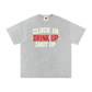Gray t-shirt with text 'Clock In Drink Up Shut Up' on a white background
