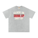 Gray t-shirt with text 'Clock In Drink Up Shut Up' on a white background